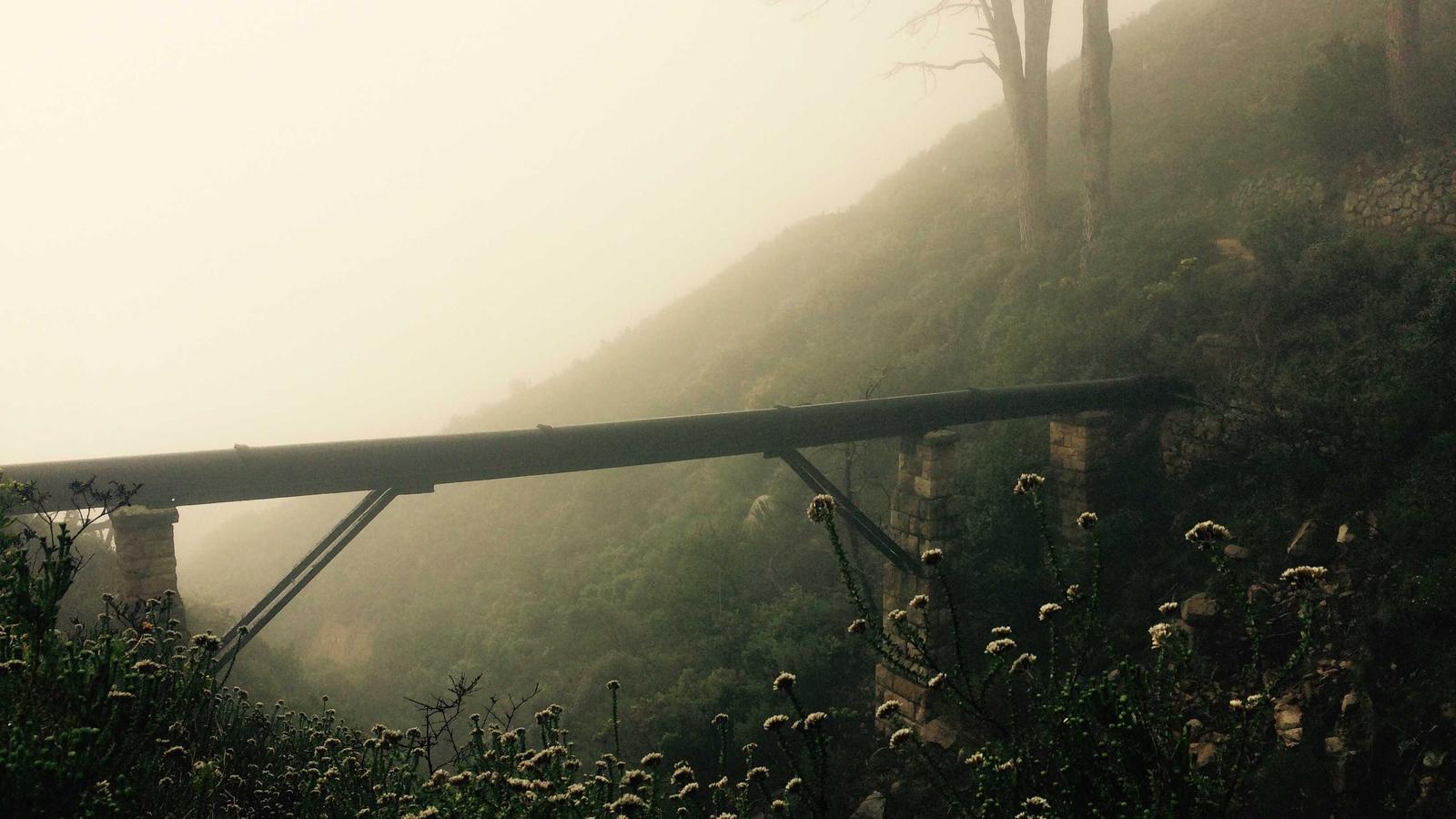 A console controller next to a hard drive on a desk