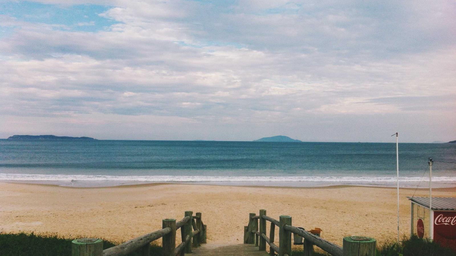 A simple notebook with three written numbers and a coffee cup