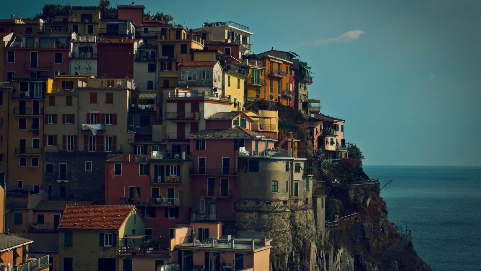 A folded set of crisp white linens stacked on a shelf