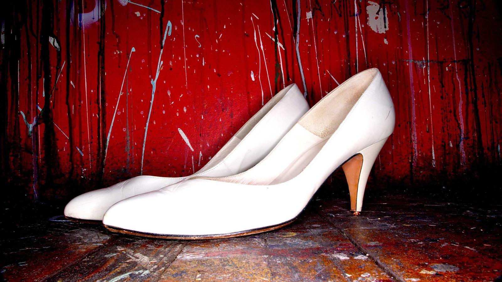 A black cast iron skillet on a stovetop with a thin film of oil